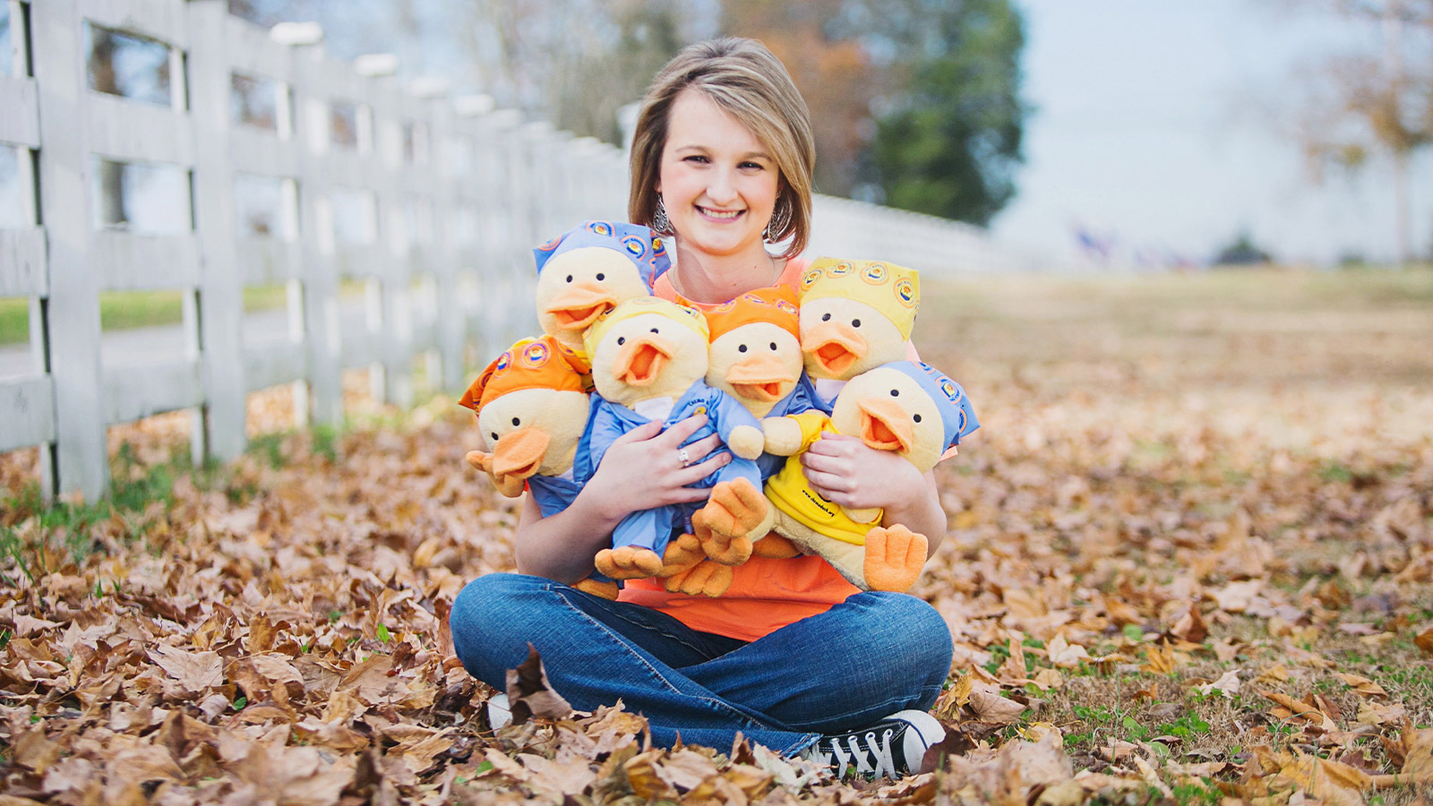 Woman holding Gabe's Chemo Duck plush dolls