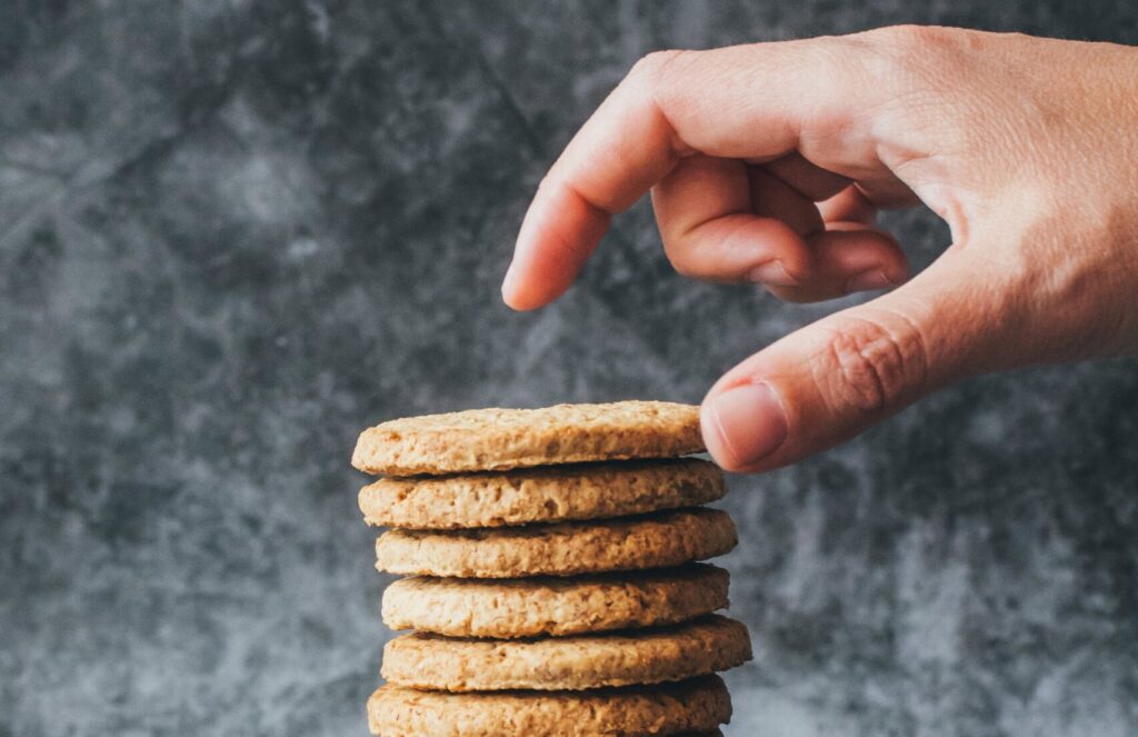 Hand reaching for a stack of cookies